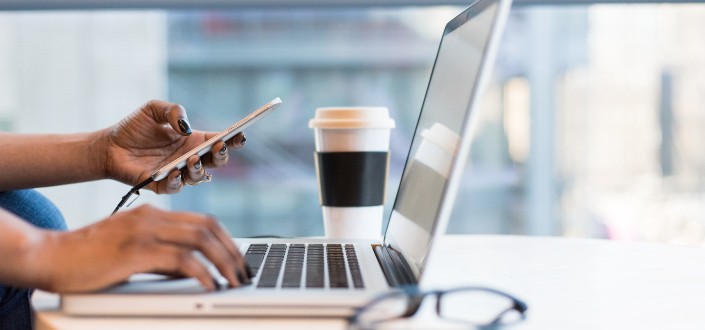 woman typing on her laptop