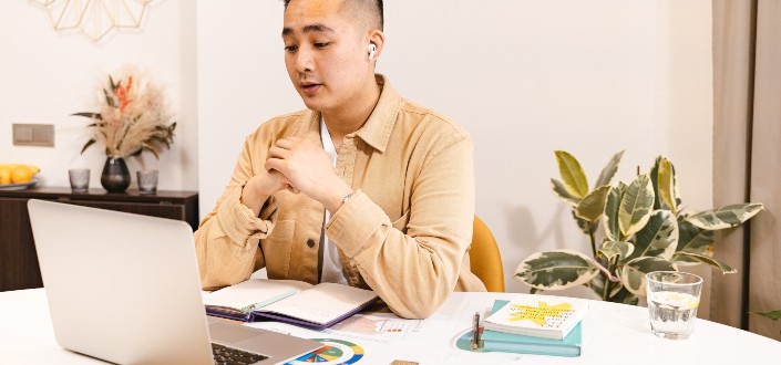 Man discussing something in front of his laptop