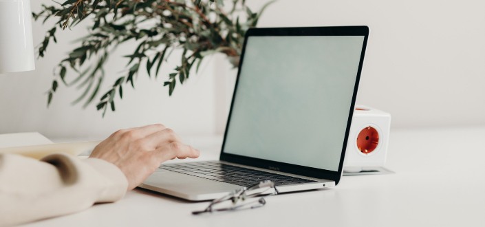 Person Using Black Laptop Computer on White Table