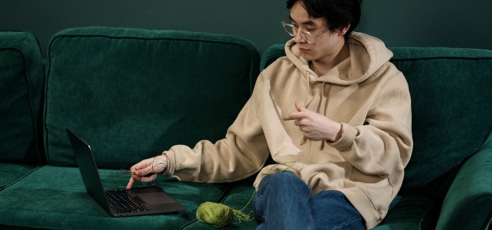 Man Sitting on a Green Couch