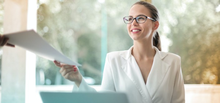 Woman handing over paperwork