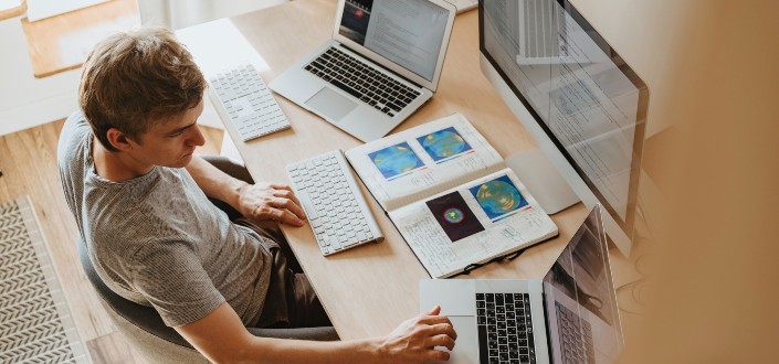 Man Using 3 Computers
