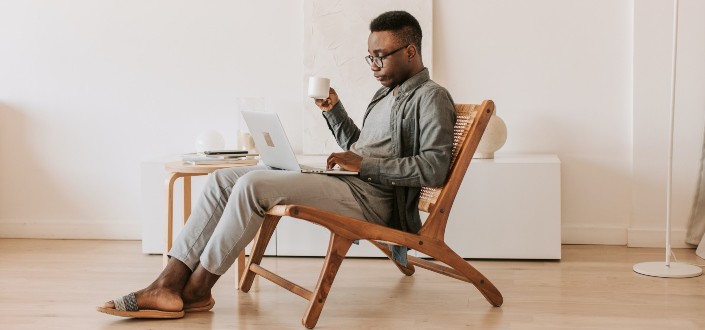 Man Sitting With a Laptop on his Lap