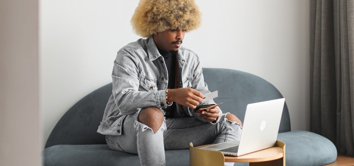 A Man Using a Laptop for Online Transaction