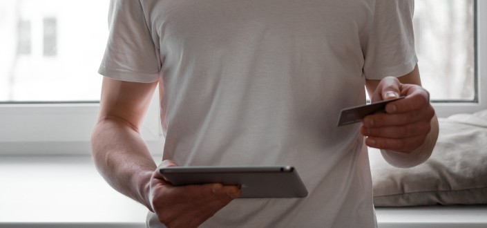 Man Using Tablet and Credit Card for Transaction