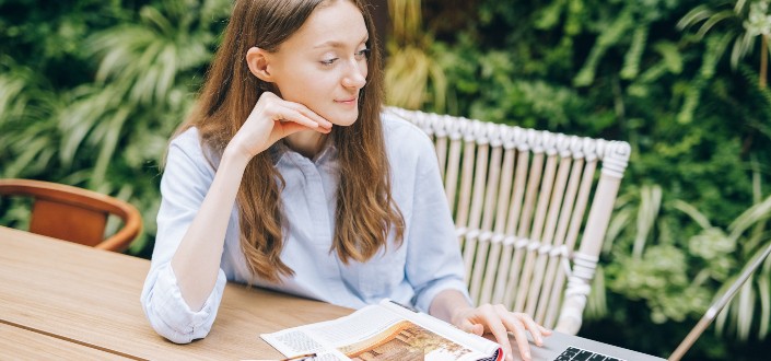 Woman Using Laptop In The Garden