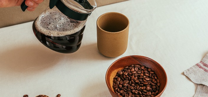Person Holding Coffee Pot