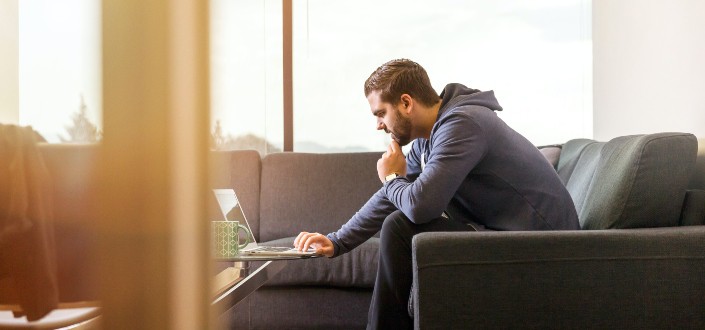 Man Using Laptop Sitting on Couch
