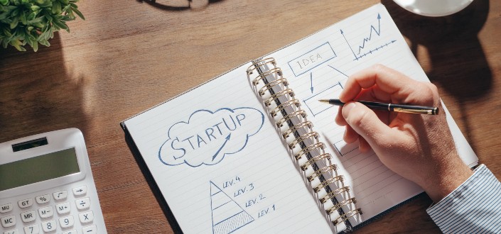 Person Writing on a Notebook