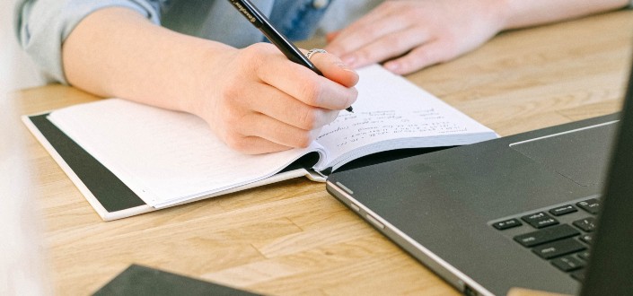 person working and taking notes