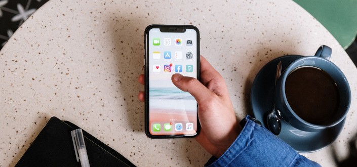Person Holding Black Iphone 7 with coffee