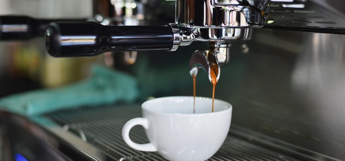 White Ceramic Mug on Espresso Machine