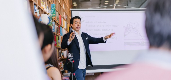 Man In Suit Standing Beside Projector Screen