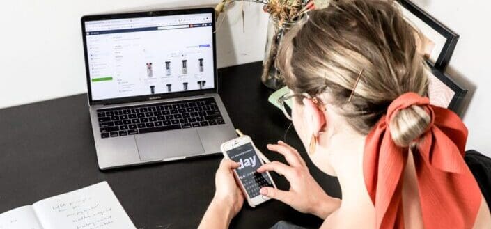 Woman Using Her Phone and Laptop