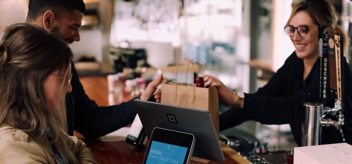 person using devices on brown table