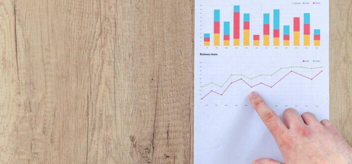 Person Pointing Paper Line Graph