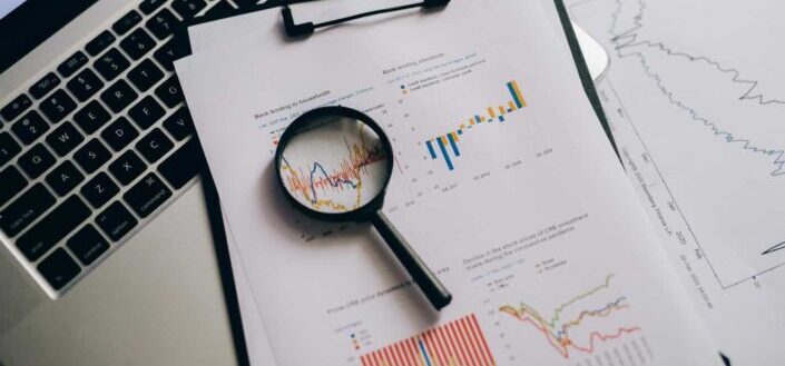Magnifying Glass on Paper with Statistical Data