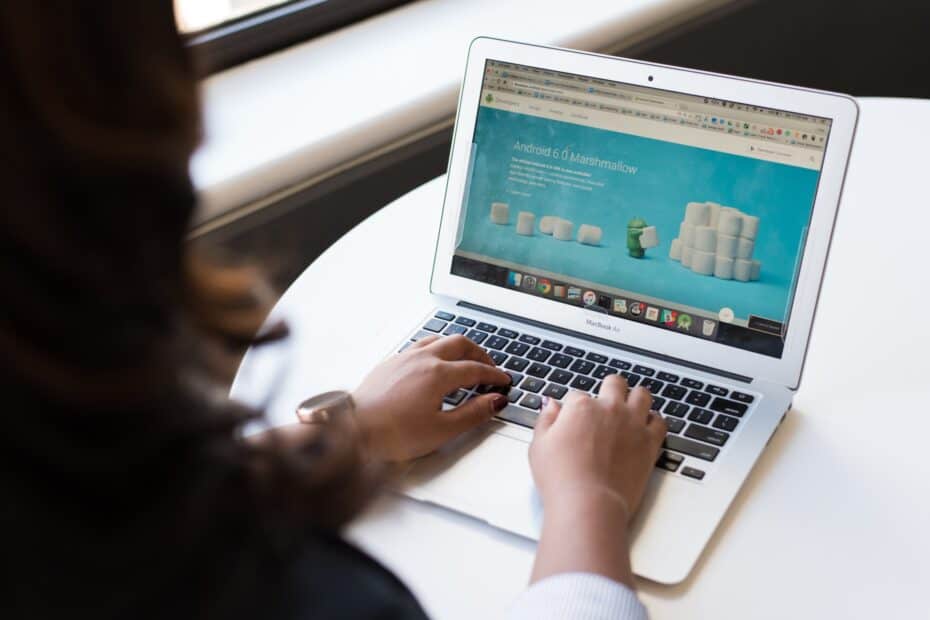 Woman Sitting Near Table Using laptop