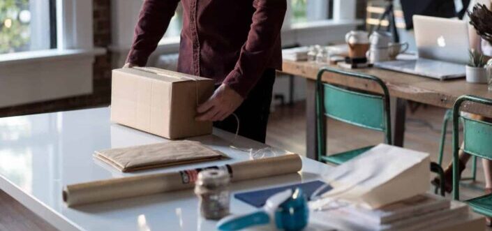 Man Holding a Brown Package