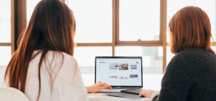 Two Women Searching For Furniture Online