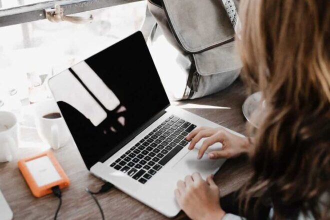 Woman Sitting Beside Table While Using Macbook - Types of CTAs