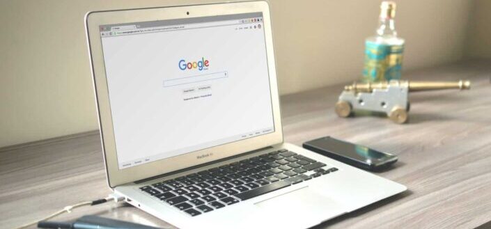 A white laptop on a wooden table