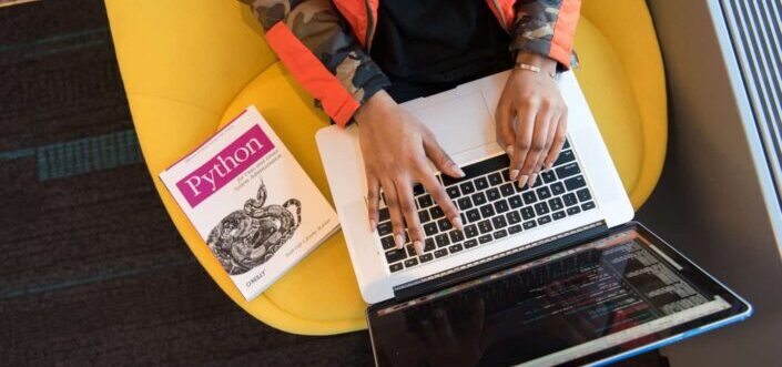 Woman Programming on a Notebook