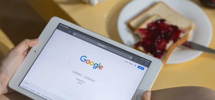 A Person Holding a Tablet Sitting