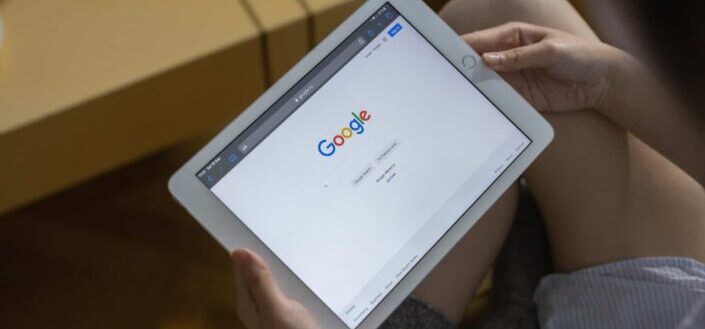 A Person Holding a Tablet Sitting