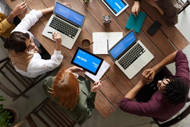 Group of People Using Macbook While Discussing - Canary Testing