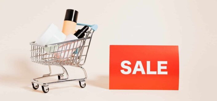 Merchandise in a Shopping Cart with a Sale Sign