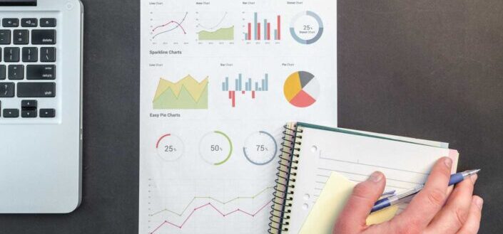 Person Holding Chart And Bar Graph
