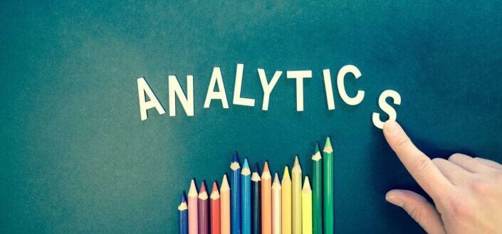 letters spelling analytics and colored pencils