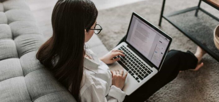 Woman Working At Home Using Her Laptop